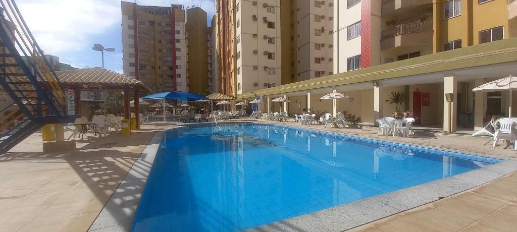 a large blue swimming pool next to some buildings at APT. 2/4 - Prive das Thermas I - 7 piscinas termal - Apclube Tur in Caldas Novas