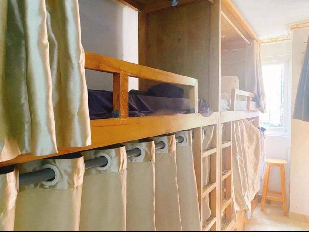 a bunk bed in a room with a curtain at LATALAND HOSTEL in Ho Chi Minh City