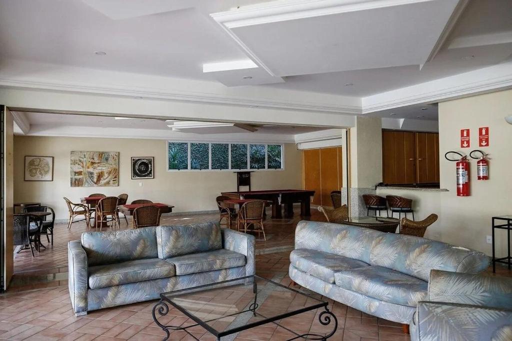 a living room with couches and a pool table at Condomínio Acqua de Riviera - Módulo 3 in Riviera de São Lourenço
