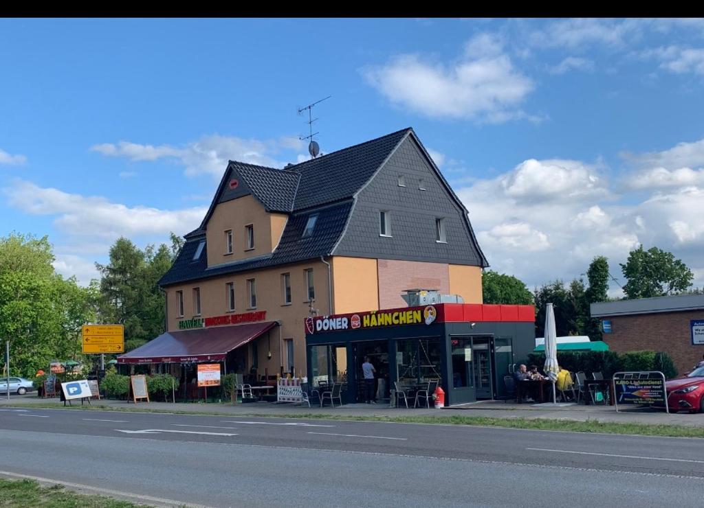 a large building on the side of a street at Pension lichtenow in Rüdersdorf