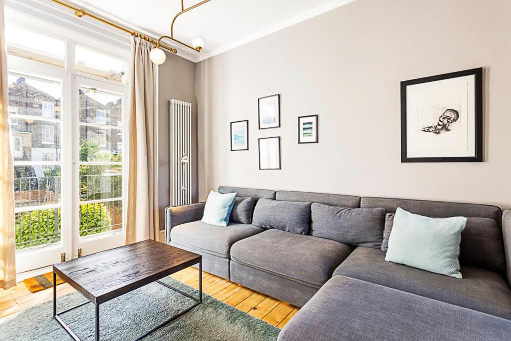 a living room with a couch and a table at Idyllic Islington Flat in London