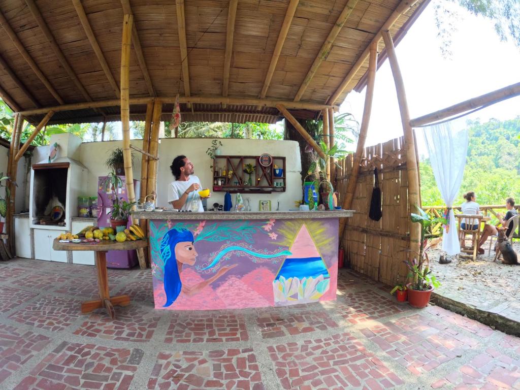 a woman standing in a kitchen in a house at MaMMa Jungla in Ayampe