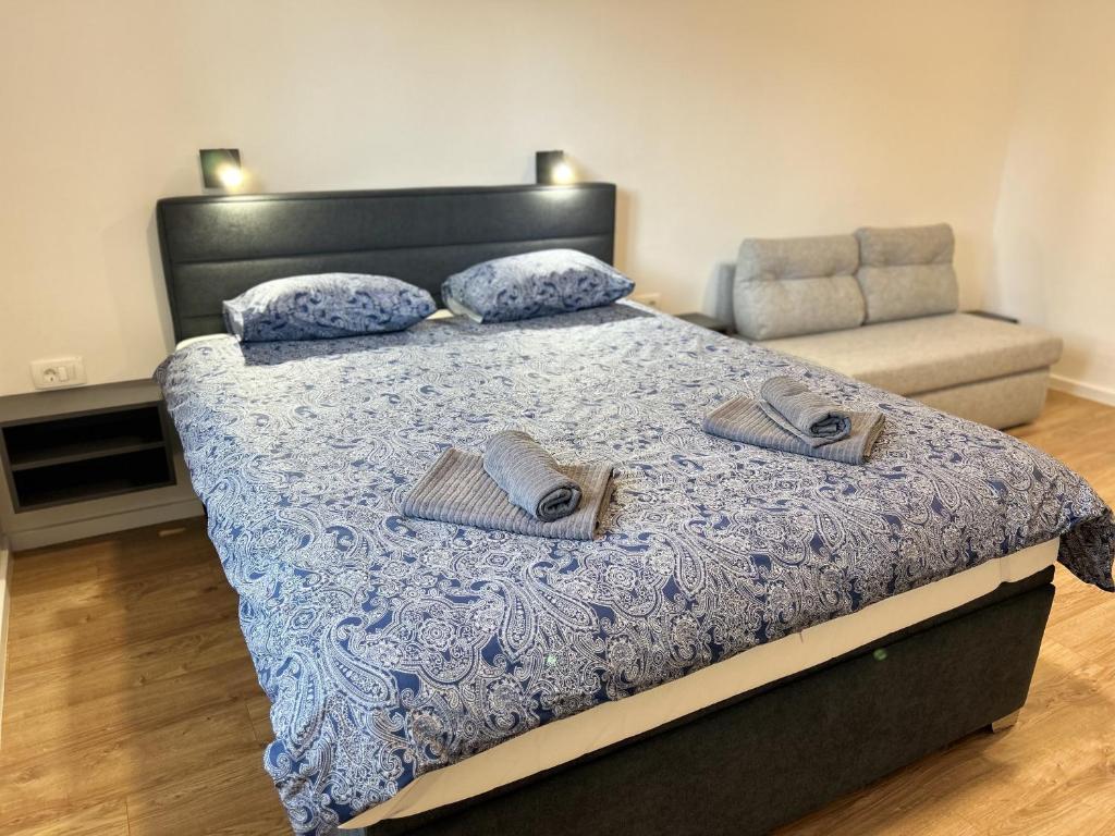 a bedroom with a bed with two slippers on it at Park Maksimir Apartments in Zagreb