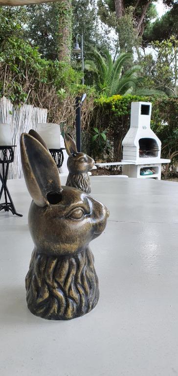 a statue of a rabbit with a vase on a table at DomusAuroom, il tuo RELAX in Viareggio