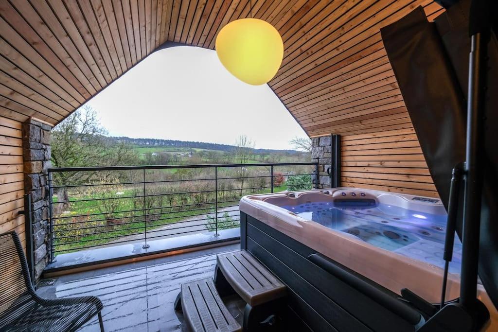 eine Whirlpool-Badewanne in einem Zimmer mit Fenster in der Unterkunft La grange d Ôlye in Hamoir