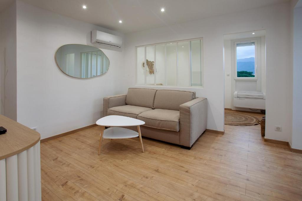 un soggiorno con divano e tavolo di Appartement T2 les pieds dans l'eau à Argeles-Sur-Mer ad Argelès-sur-Mer