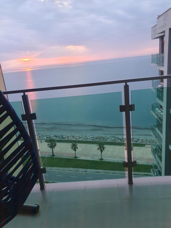 a view of the ocean from a balcony of a building at The Fresh Wave hotel in Batumi