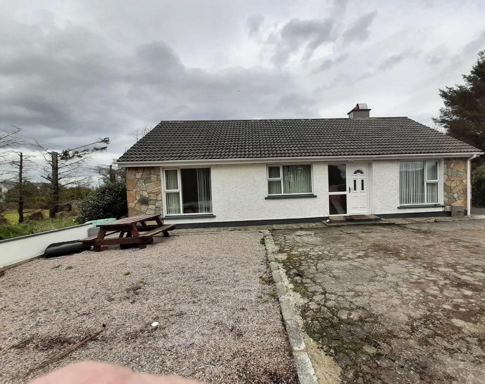 a house with a picnic table in front of it at Radharc an tSléibhe - Mountain View - Eircode F92R2R8 in Letterkenny
