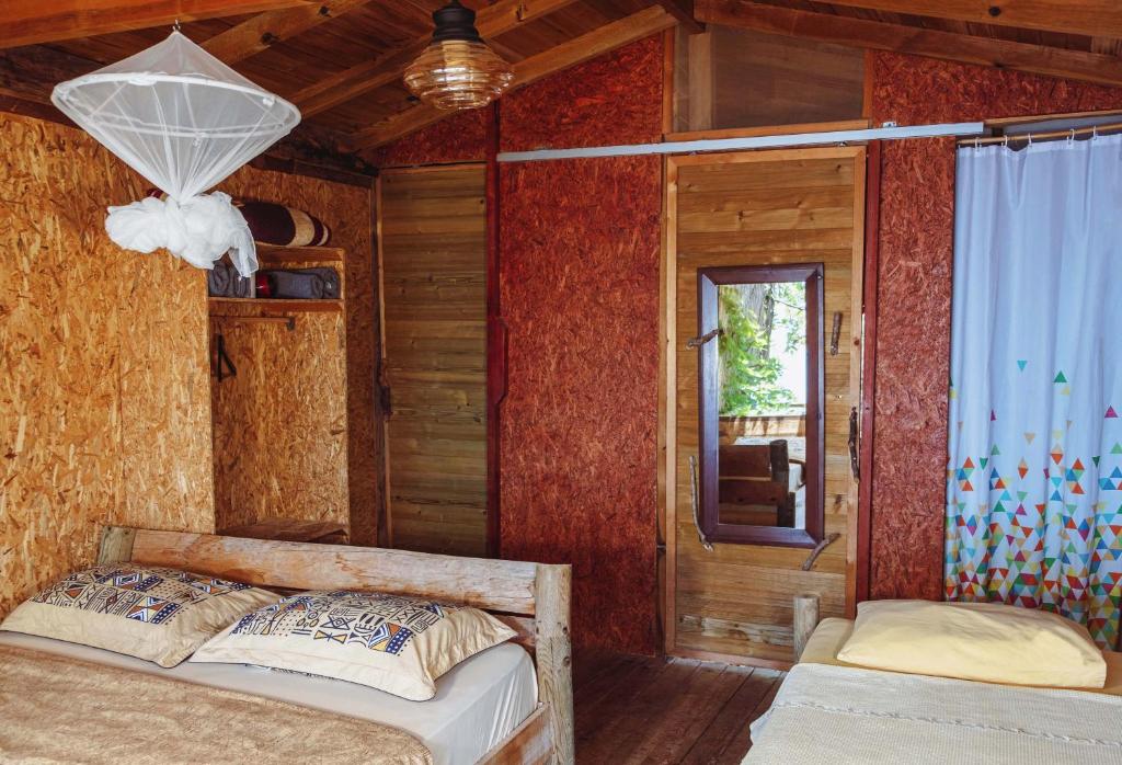 a bedroom with two beds in a room with a window at Deep Ocean Camping-Adults Only in Faralya
