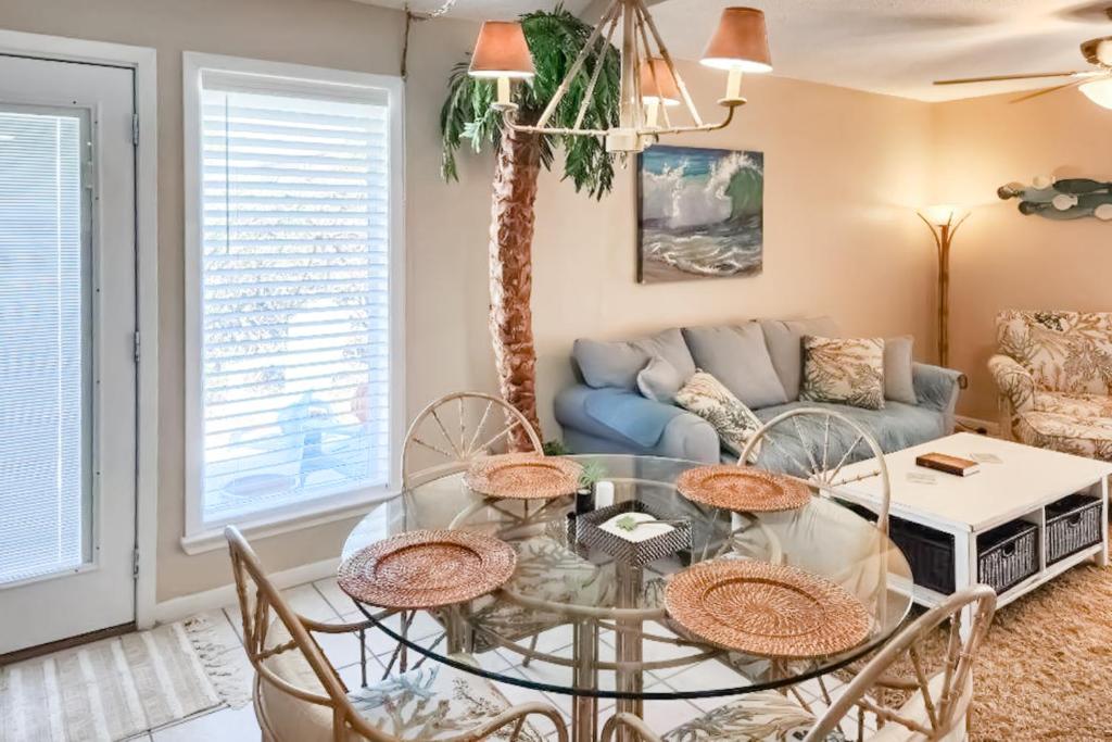 a living room with a glass table and chairs at Sea Cabin 2D in Destin