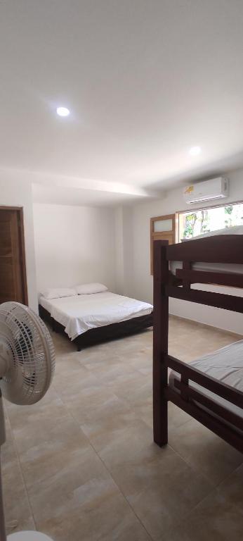 a room with two bunk beds and a fan at Cabañas vacacional El Porvenir in San Antero