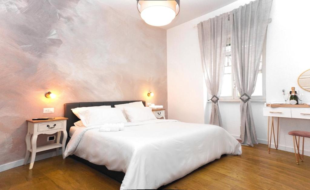 a bedroom with a bed and a painting on the wall at Vatican Suite Apartment - Rome City Centre in Rome