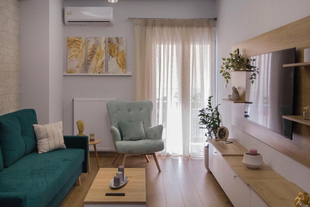 a living room with a green couch and a chair at Luxurious apt near Ampelokipoi Metro station in Athens