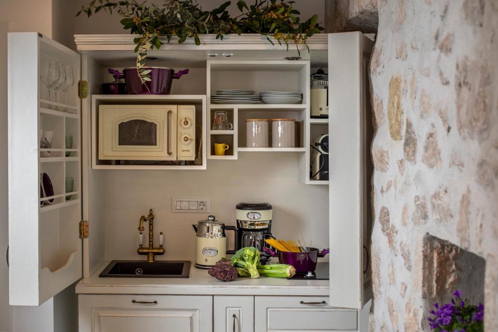 a kitchen with white cabinets and a microwave at Stayeva 11 in Dubrovnik