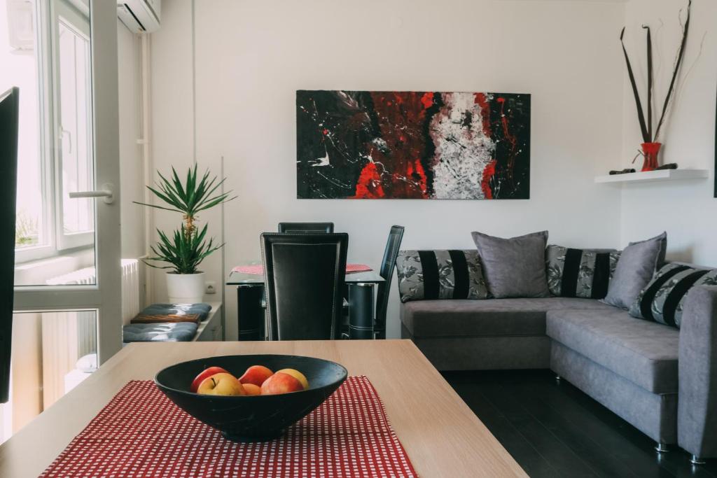 a living room with a bowl of fruit on a table at Smart hostel in Belgrade