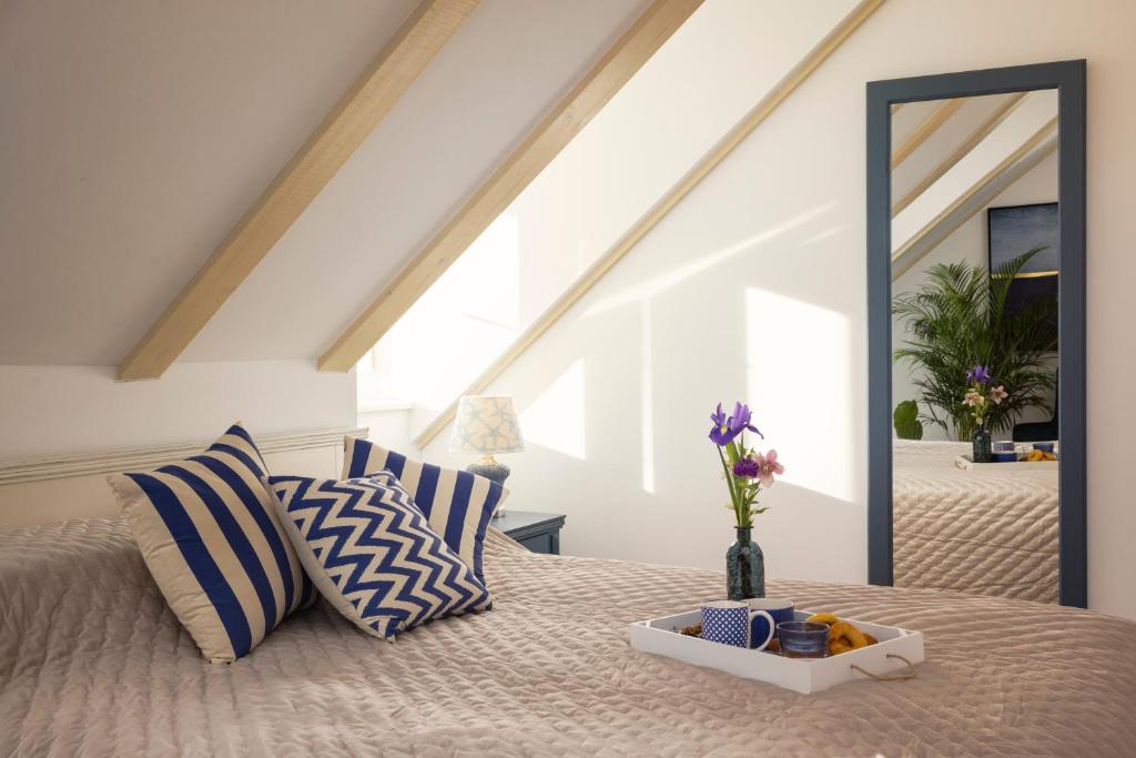 a bed with blue and white pillows and a mirror at Stayeva 11 in Dubrovnik