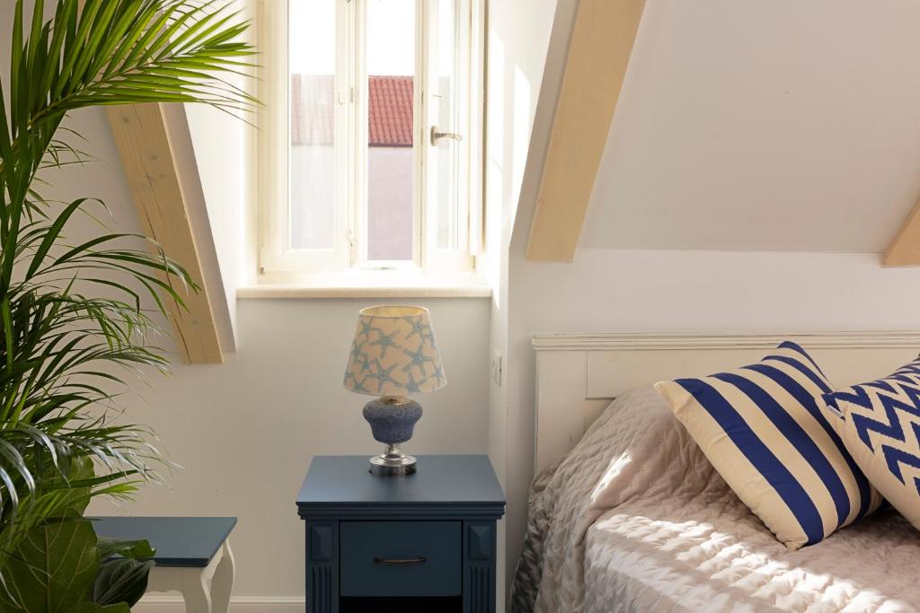 a bedroom with a bed and a table with a lamp at Stayeva 11 in Dubrovnik