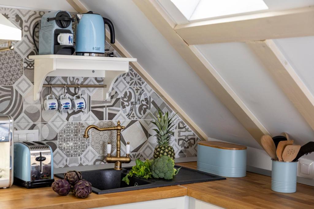 a kitchen with a sink and a wall with tiles at Stayeva 11 in Dubrovnik