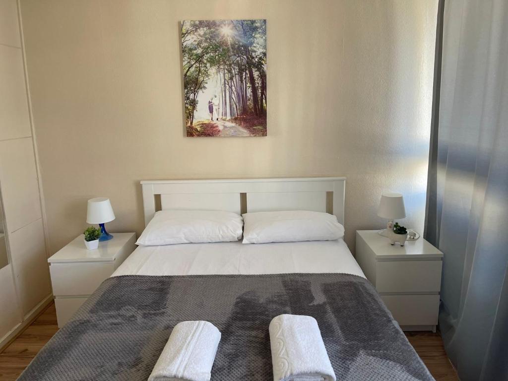 a bedroom with a large bed with two night stands at 2-bedroom Flat in Regents Park-Euston-Camden in London