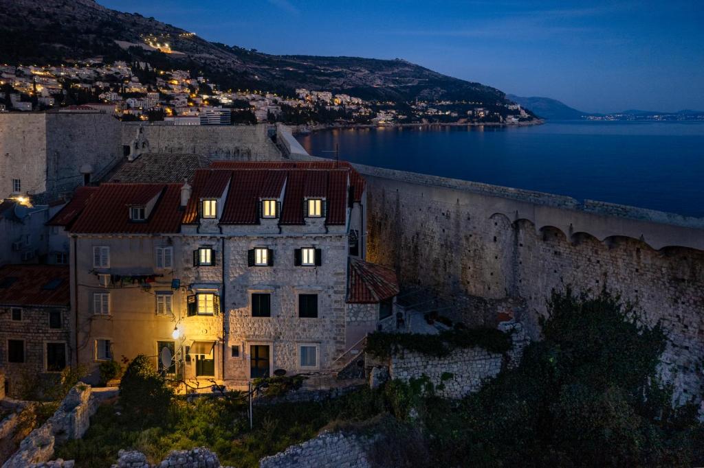 an old building in front of a wall at night at Stayeva 11 in Dubrovnik