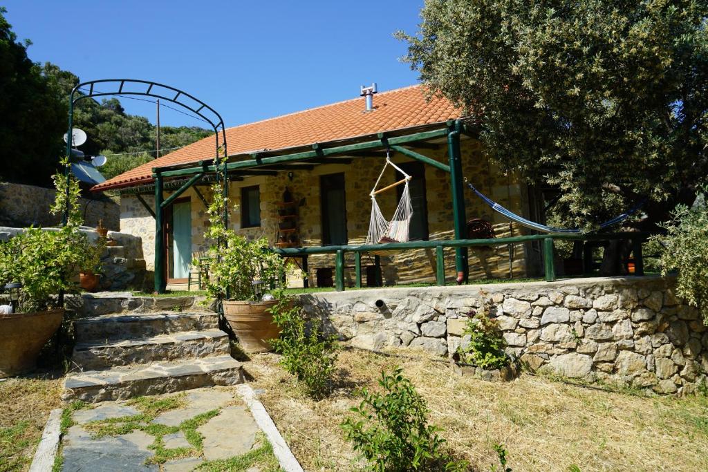a house with a stone wall in front of it at Elpida Country House -Paleochora-Anidri in Palaiochora