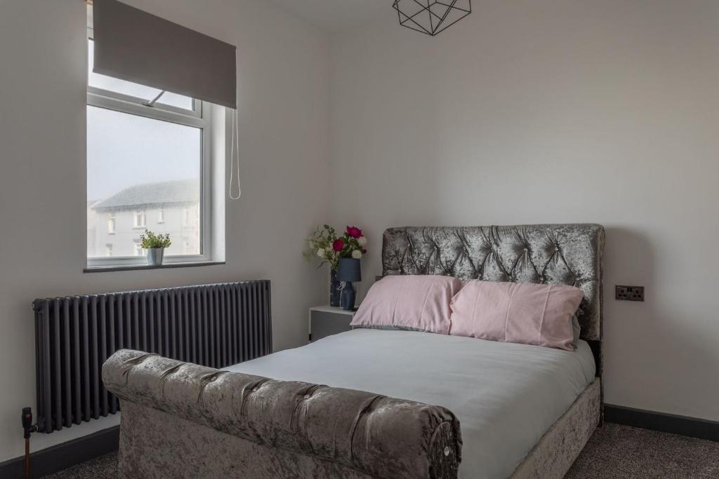 a bedroom with a bed and a couch at RESIDENCY LUXURY SEAFRONT HOTEL in Blackpool