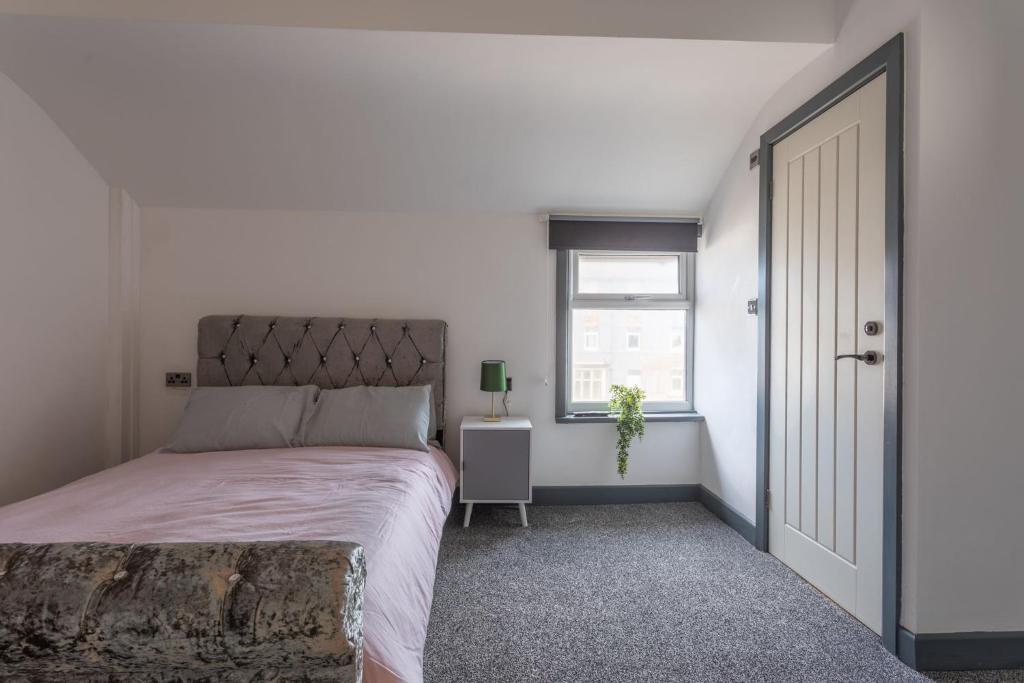 a bedroom with a large bed and a window at RESIDENCY LUXURY SEAFRONT HOTEL in Blackpool