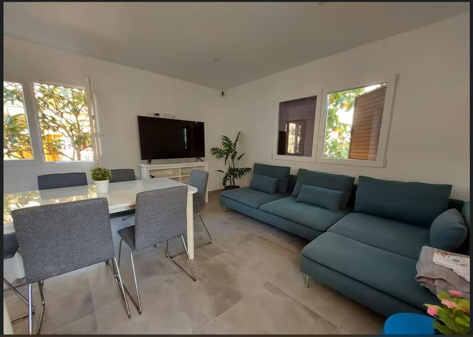 a living room with a blue couch and a table at Casa de alquiler Moncófar Playa in Moncófar