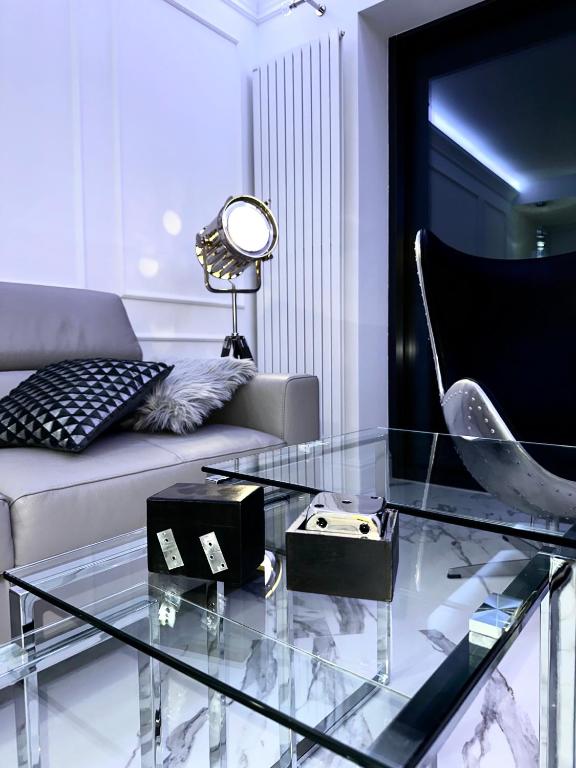 a living room with a couch and a glass table at Hanza Tower Apartament Times Square in Szczecin