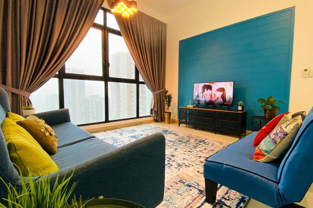 a living room with a couch and a tv at The Icon4 Condo in IOI City Mall Putrajaya, Netflix in Putrajaya