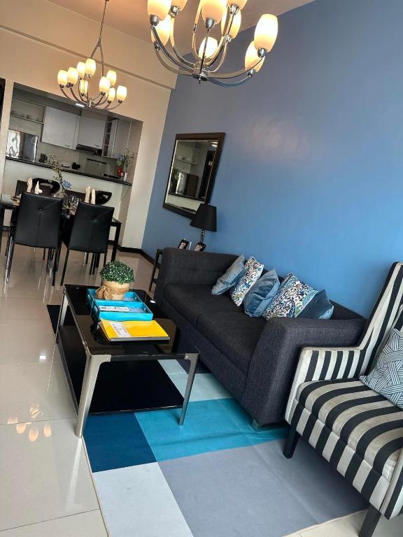 a living room with a couch and a table at Suites de Marina Manila with Netflix in Manila