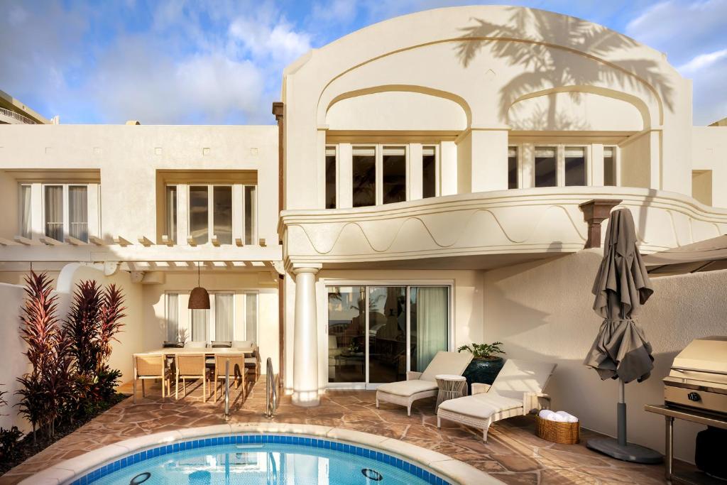 a house with a swimming pool in front of it at The Villas at Fairmont Kea Lani in Wailea