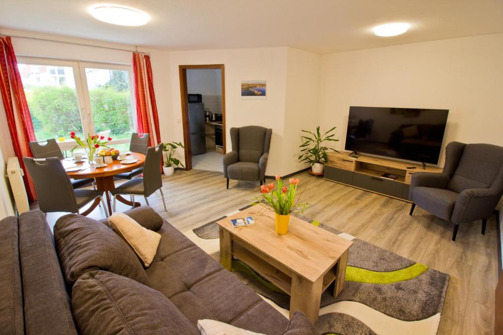 a living room with a couch and a table at Ferienwohnung Tukan Apartment Dresden Laubegast WLAN TV Ebike in Dresden