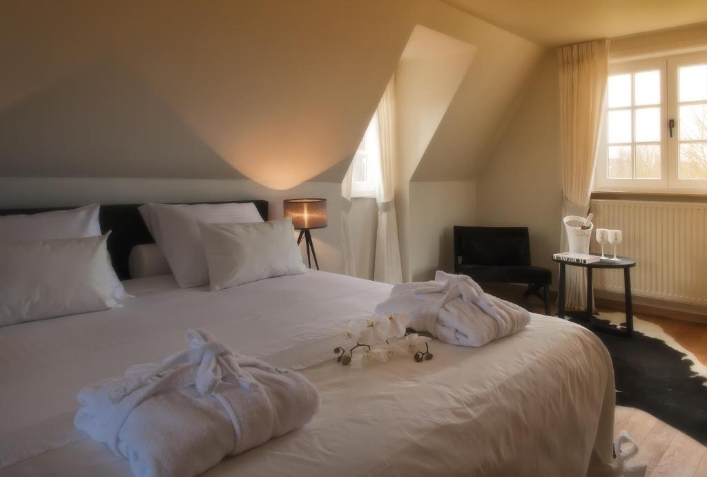 Postel nebo postele na pokoji v ubytování B&B Colombe Blanche