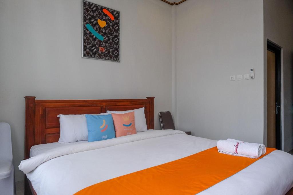 Postel nebo postele na pokoji v ubytování Sans Hotel Kumbang Yogyakarta by RedDoorz