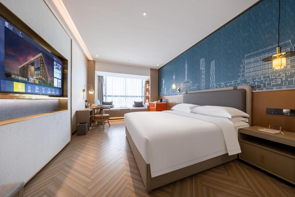 Postel nebo postele na pokoji v ubytování Guangzhou Baiyun Airport MeHood Liz Hotel Free Shuttle Bus To Airport