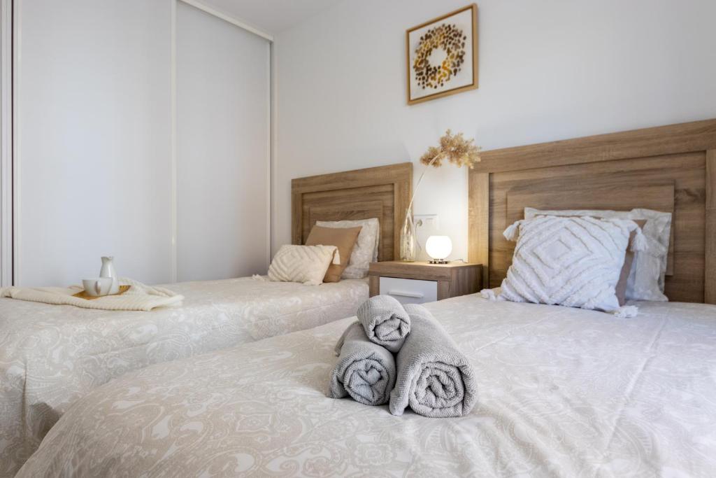 A bed or beds in a room at BOOOOM Apartment Salou Beach