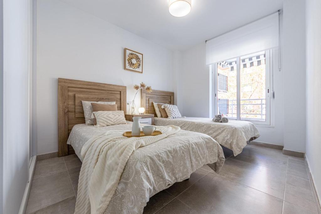 A bed or beds in a room at BOOOOM Apartment Salou Beach