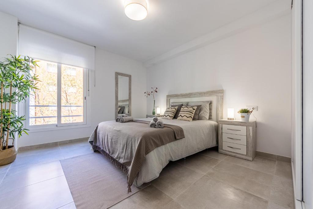 A bed or beds in a room at BOOOOM Apartment Salou Beach