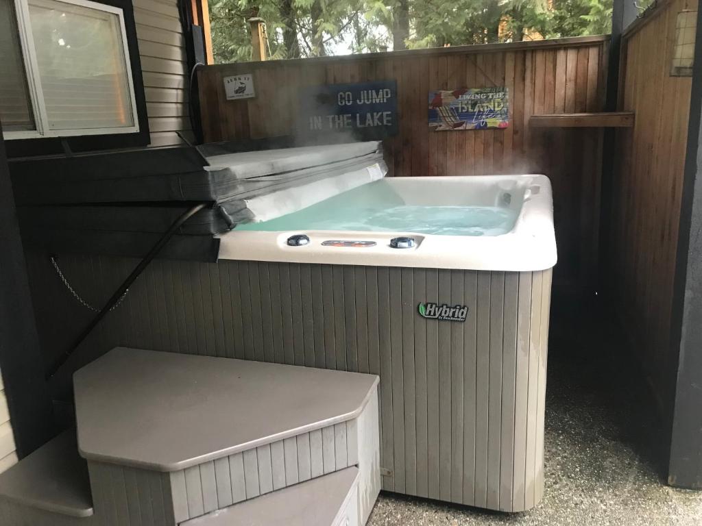 a hot tub in the side of a tiny house at Hot Tub Hideaway in Shawnigan Lake