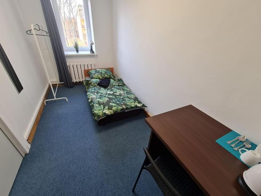 a room with a desk and a bed in a room at Fantastic Mokotow - FMG Pokoj P in Warsaw