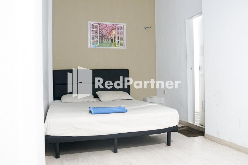 Letto o letti in una camera di Cosmo Harmoni RedPartner