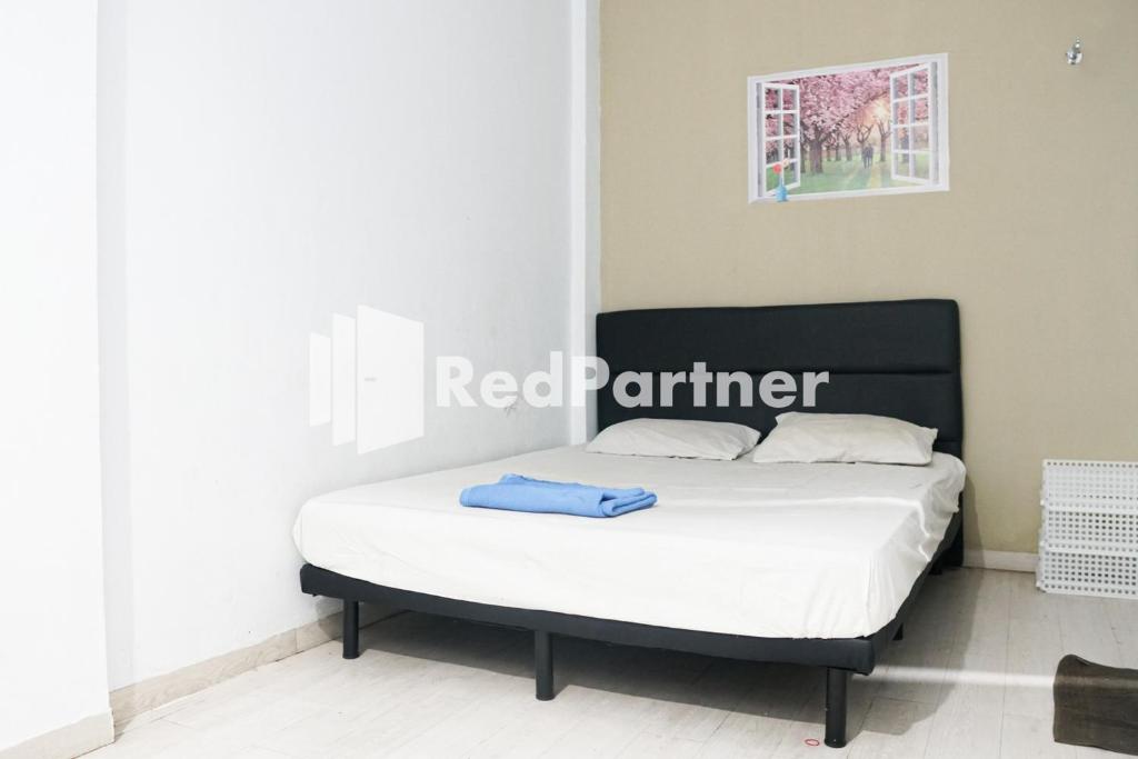 Letto o letti in una camera di Cosmo Harmoni RedPartner