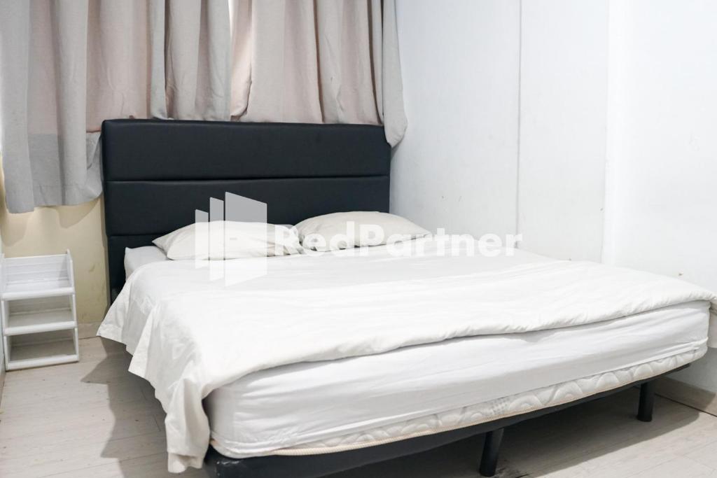 Letto o letti in una camera di Cosmo Harmoni RedPartner