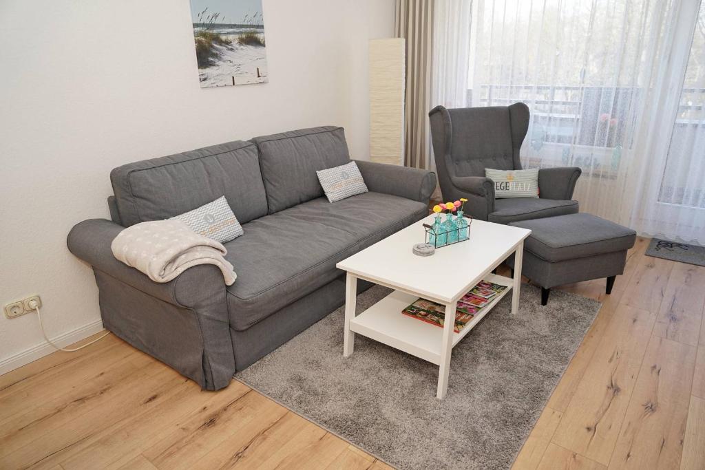 a living room with a couch and a table at Ferienwohnung mit neuer Küche u Bad - W-LAN in Damp