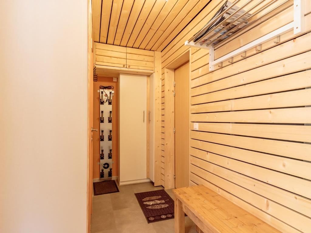 a home dressing room with a wooden wall at Appartement La Plagne-Tarentaise, 2 pièces, 4 personnes - FR-1-351-152 in La Plagne Tarentaise