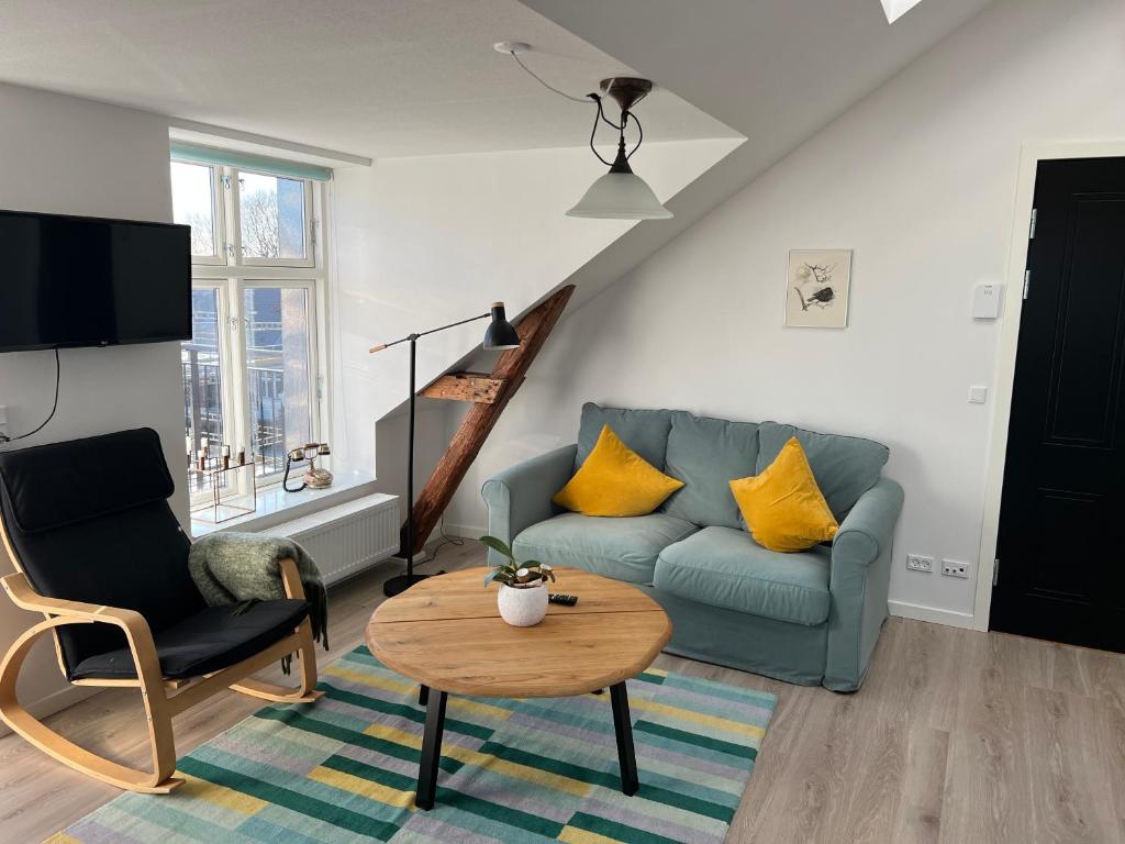 a living room with a couch and a table at Hygge Loft in Varde