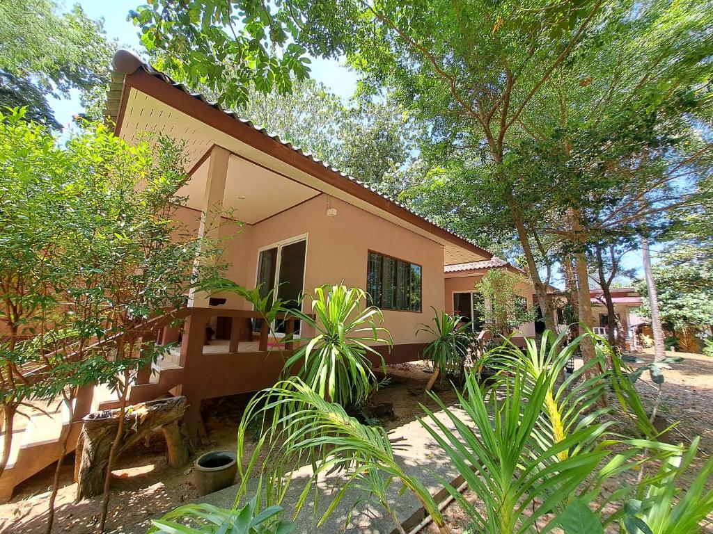 a small house in the middle of trees at Baan Long Beach in Ko Lanta