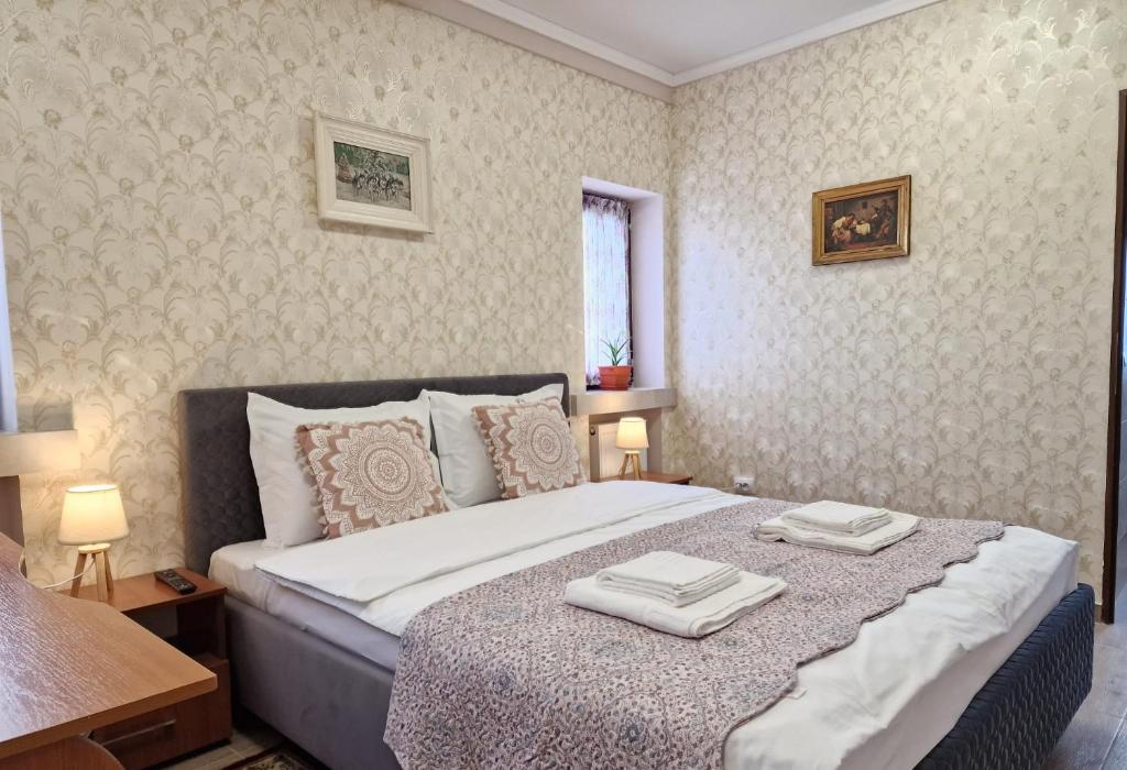 una camera da letto con un letto con due asciugamani sopra di Laroka House Arty and Cosy studio Universitate Center a Bucarest