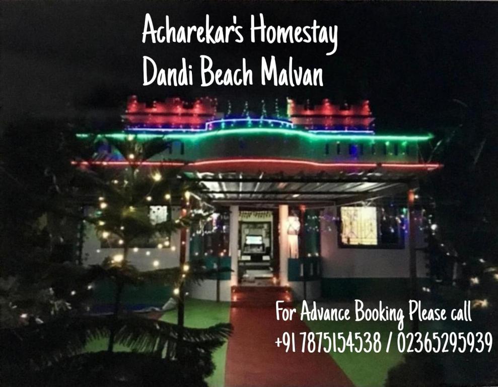 una señal para una casa con luces de Navidad en ella en Acharekar's Home stay - Adorable AC and Non AC Rooms with free Wi-Fi, en Malvan
